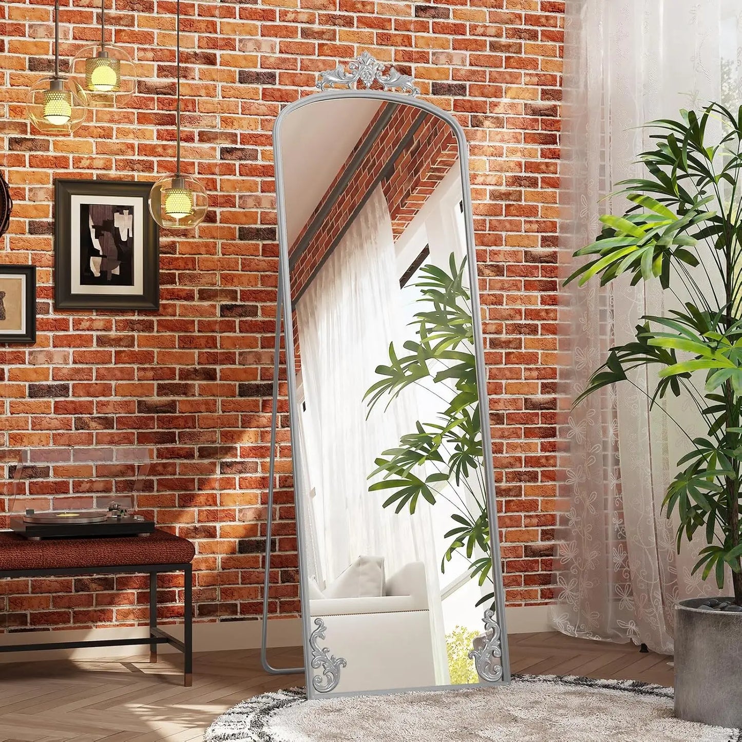 Arched full-length mirror with carved metal frame