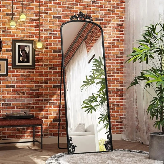 Arched full-length mirror with carved metal frame